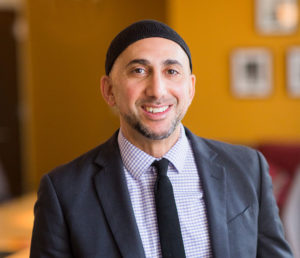 headshot of rami nashashibi, smiling