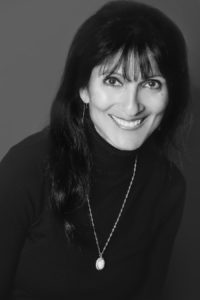 black and white picture of manal fakhoury, smiling